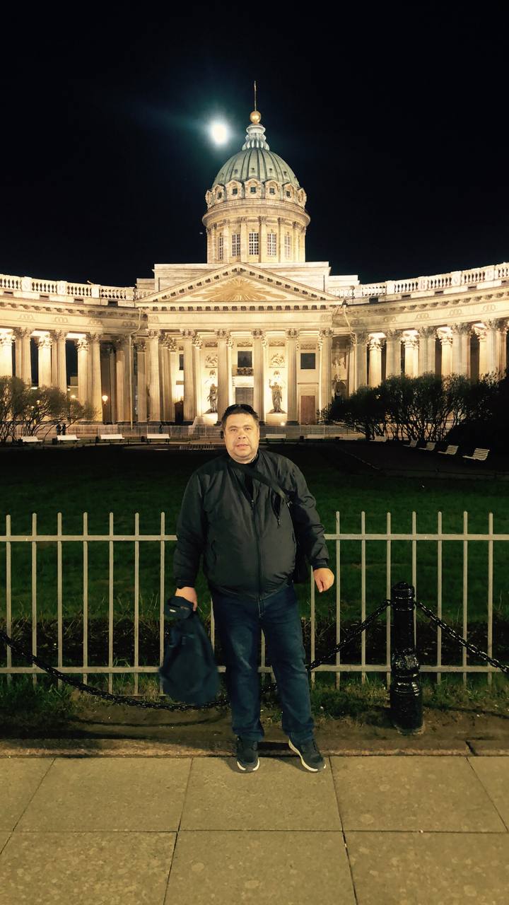 A person standing in an urban area with buildings in the background
